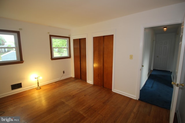 65 Albert Ave, Milltown, NJ 08850 - unfurnished bedroom with two closets, wood finished floors, and baseboards