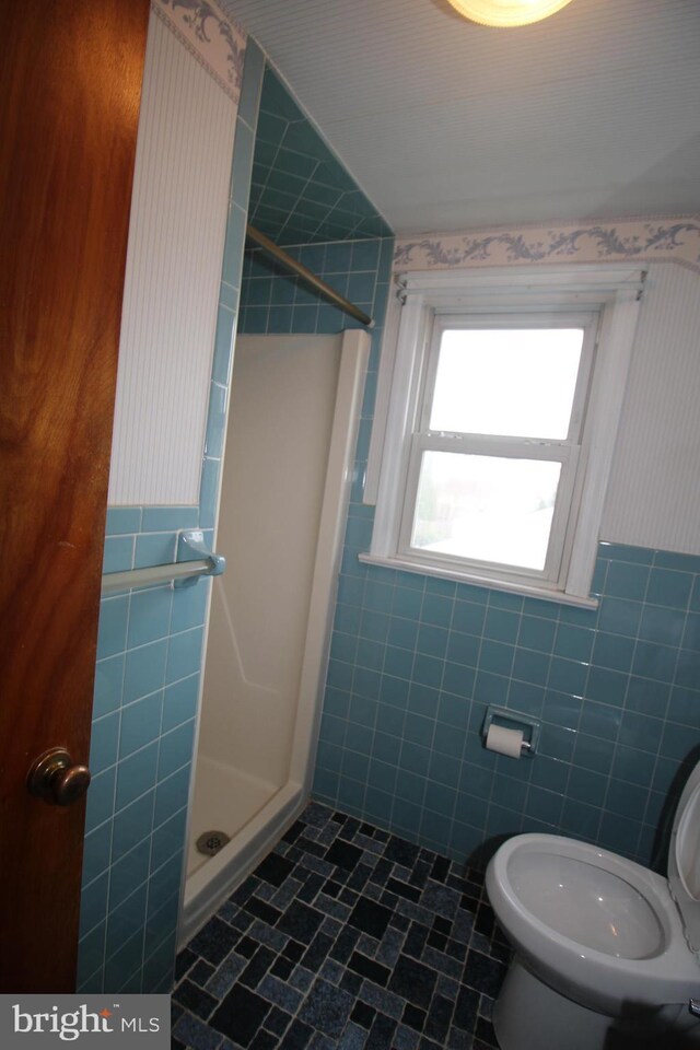 65 Albert Ave, Milltown, NJ 08850 - bathroom featuring tile walls, a shower stall, toilet, tile patterned flooring, and wainscoting