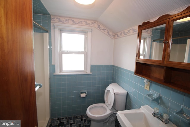 65 Albert Ave, Milltown, NJ 08850 - bathroom with a stall shower, vaulted ceiling, toilet, tile walls, and a sink