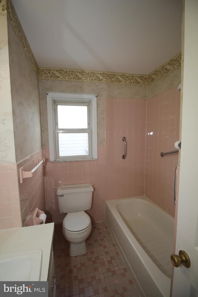 65 Albert Ave, Milltown, NJ 08850 - bathroom featuring vanity, tile walls, toilet, and a wainscoted wall