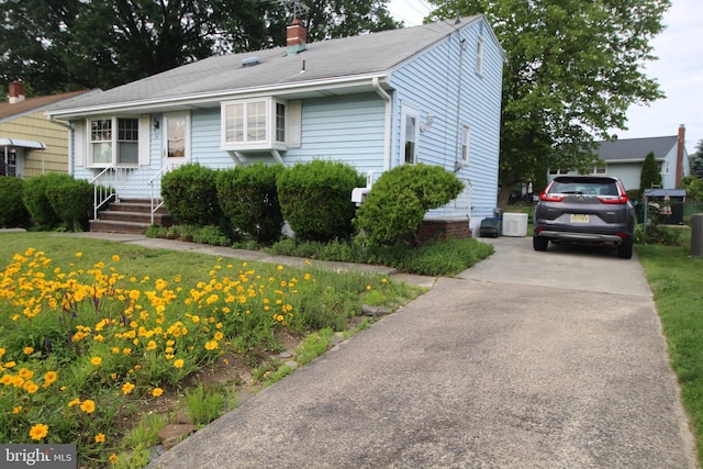 65 Albert Ave, Milltown, NJ 08850 - view of front of house featuring a chimney, a front lawn, and concrete driveway