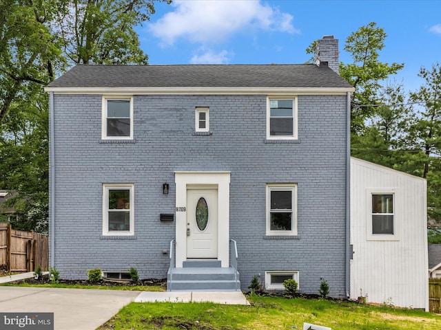 8709 Bradford Rd, Silver Spring, MD 20901 - colonial home featuring a chimney and brick siding