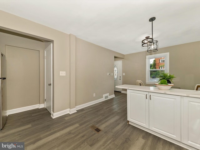 8709 Bradford Rd, Silver Spring, MD 20901 - kitchen with dark wood-type flooring, baseboards, white cabinetry, light countertops, and pendant lighting