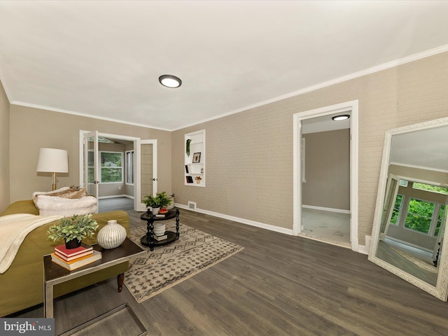 8709 Bradford Rd, Silver Spring, MD 20901 - living area with brick wall, ornamental molding, wood finished floors, and baseboards