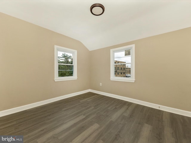 8709 Bradford Rd, Silver Spring, MD 20901 - empty room with vaulted ceiling, dark wood-style floors, and baseboards