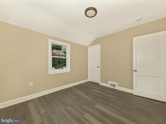 8709 Bradford Rd, Silver Spring, MD 20901 - spare room featuring vaulted ceiling, dark wood-type flooring, baseboards, and a smoke detector