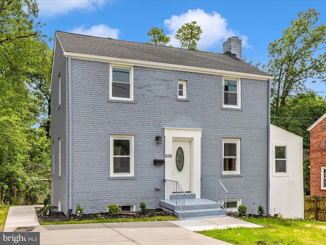 8709 Bradford Rd, Silver Spring, MD 20901 - colonial home featuring a chimney and brick siding