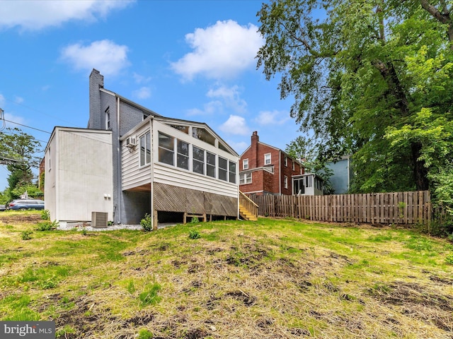 8709 Bradford Rd, Silver Spring, MD 20901 - rear view of property featuring a chimney, a sunroom, and central air condition unit
