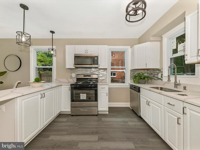 8709 Bradford Rd, Silver Spring, MD 20901 - kitchen featuring stainless steel appliances, white cabinets, and decorative backsplash