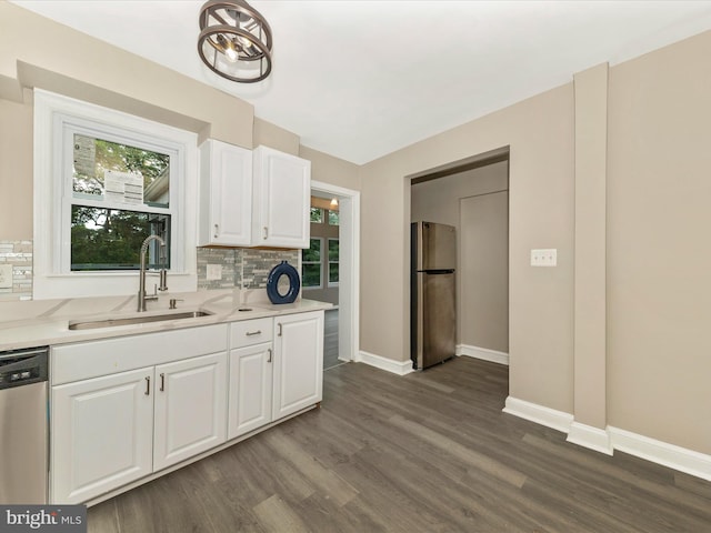 8709 Bradford Rd, Silver Spring, MD 20901 - kitchen featuring stainless steel appliances, a sink, decorative backsplash, dark wood-style flooring, and baseboards
