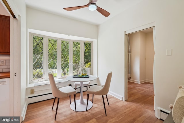 9101 Sligo Creek Pkwy, Silver Spring, MD 20901 - dining room with a baseboard radiator, healthy amount of natural light, and light wood-type flooring