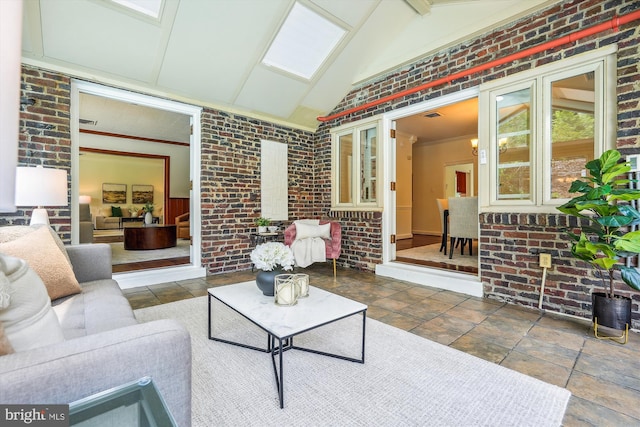 9101 Sligo Creek Pkwy, Silver Spring, MD 20901 - living area featuring brick wall, high vaulted ceiling, crown molding, and stone finish flooring