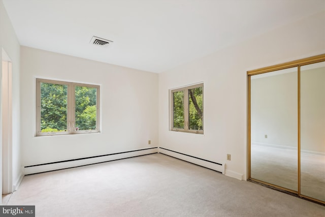 9101 Sligo Creek Pkwy, Silver Spring, MD 20901 - unfurnished bedroom with light colored carpet, a baseboard heating unit, and a closet