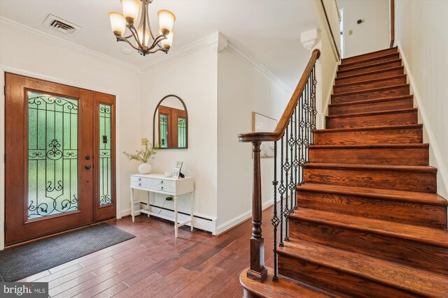 9101 Sligo Creek Pkwy, Silver Spring, MD 20901 - foyer featuring stairs, a chandelier, dark wood-style flooring, a baseboard heating unit, and crown molding
