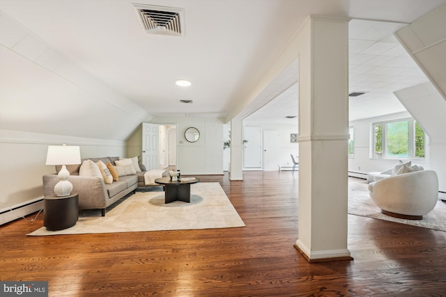 9101 Sligo Creek Pkwy, Silver Spring, MD 20901 - living area featuring dark wood finished floors, vaulted ceiling, ornate columns, and a baseboard radiator