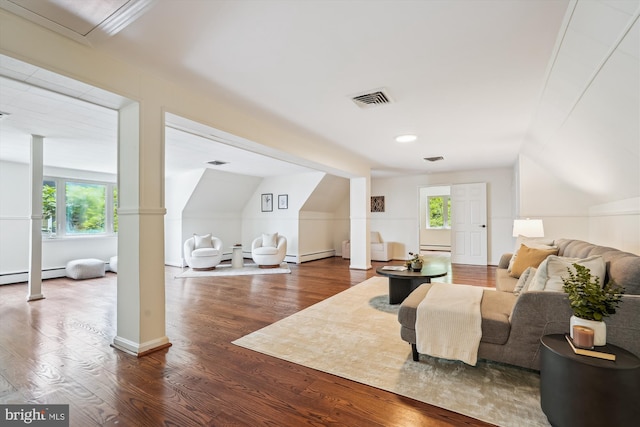 9101 Sligo Creek Pkwy, Silver Spring, MD 20901 - living room featuring wood finished floors, a baseboard radiator, healthy amount of natural light, lofted ceiling, and ornate columns