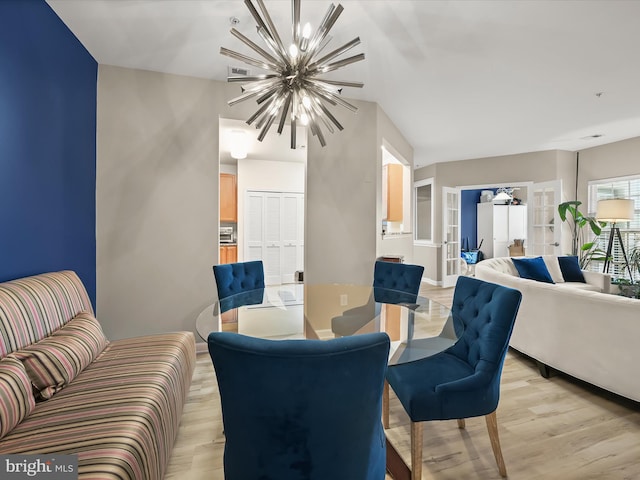 5307 Wyndholme Cir Unit 302, Baltimore, MD 21229 - dining space featuring a chandelier, light wood-style flooring, and french doors