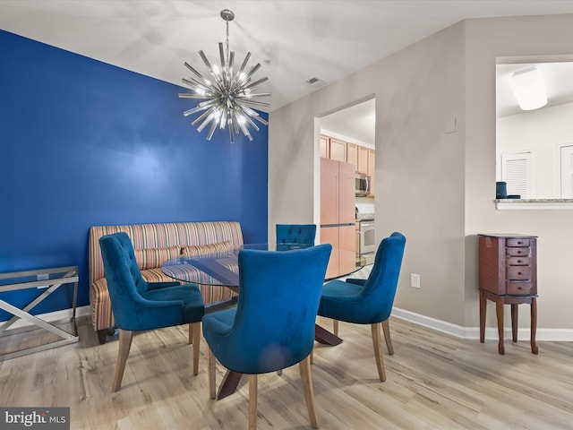 5307 Wyndholme Cir Unit 302, Baltimore, MD 21229 - dining room with a chandelier, light wood-style flooring, and baseboards