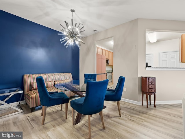 5307 Wyndholme Cir Unit 302, Baltimore, MD 21229 - dining area featuring light wood finished floors, a chandelier, and baseboards