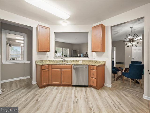 5307 Wyndholme Cir Unit 302, Baltimore, MD 21229 - kitchen with stainless steel dishwasher, a sink, light wood finished floors, and a chandelier