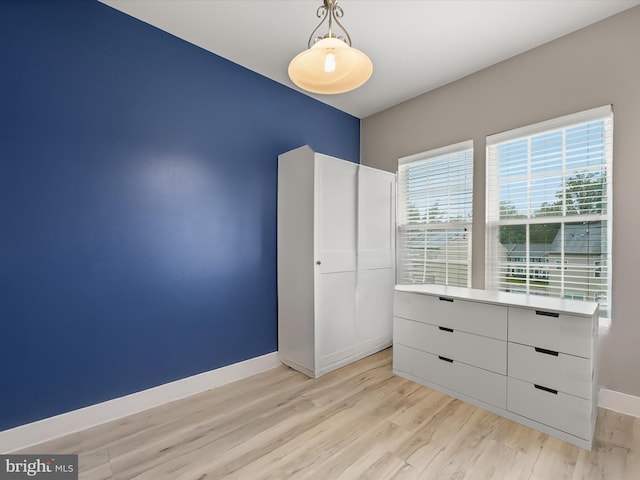 5307 Wyndholme Cir Unit 302, Baltimore, MD 21229 - unfurnished bedroom featuring baseboards and light wood finished floors