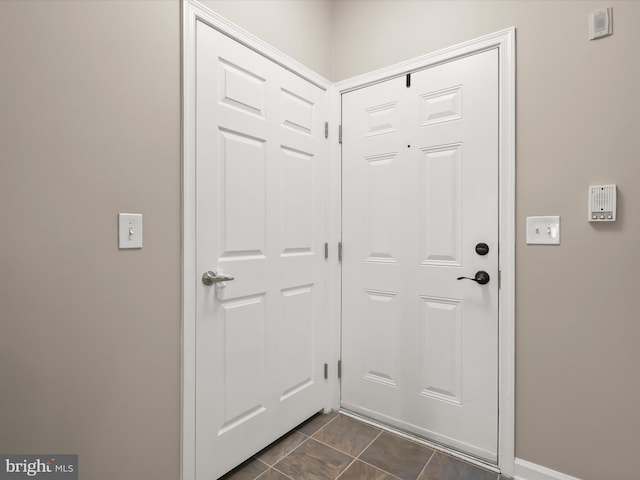5307 Wyndholme Cir Unit 302, Baltimore, MD 21229 - doorway with dark tile patterned floors and baseboards