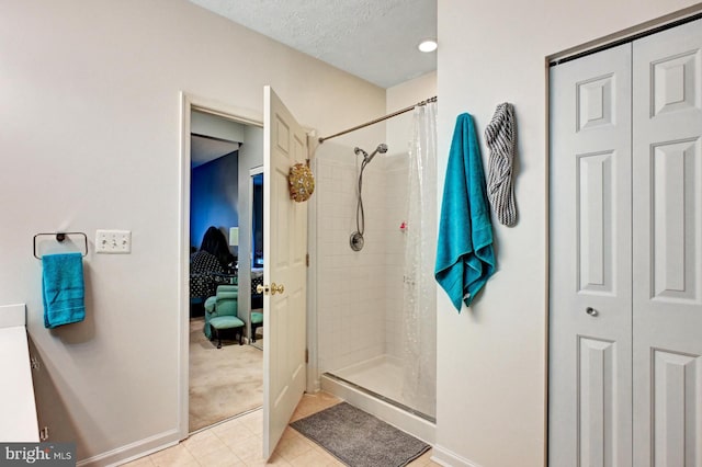 9615 Haven Farm Rd Unit 9615G, Perry Hall, MD 21128 - ensuite bathroom featuring tile patterned flooring, a stall shower, a closet, and a textured ceiling