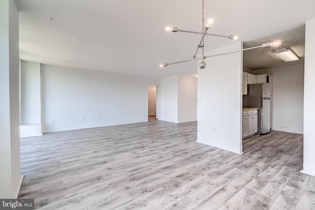 1225 Martha Custis Dr Unit 1210, Alexandria, VA 22302 - unfurnished living room with light wood-style floors and a chandelier