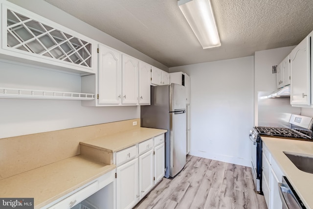 1225 Martha Custis Dr Unit 1210, Alexandria, VA 22302 - kitchen featuring appliances with stainless steel finishes, under cabinet range hood, open shelves, light wood-style flooring, and white cabinetry