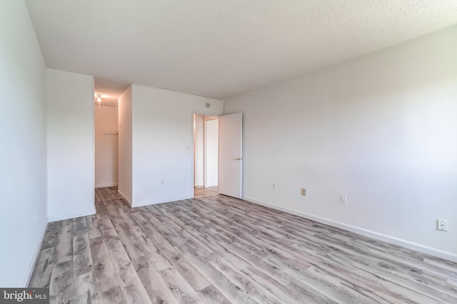 1225 Martha Custis Dr Unit 1210, Alexandria, VA 22302 - unfurnished bedroom featuring light wood finished floors, baseboards, a closet, and a walk in closet