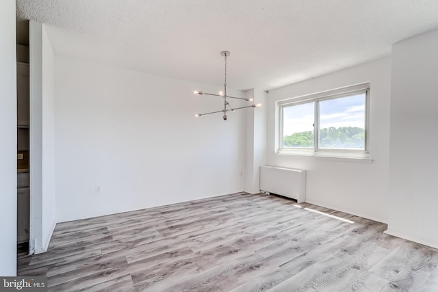 1225 Martha Custis Dr Unit 1210, Alexandria, VA 22302 - unfurnished dining area with wood finished floors, radiator, and a chandelier