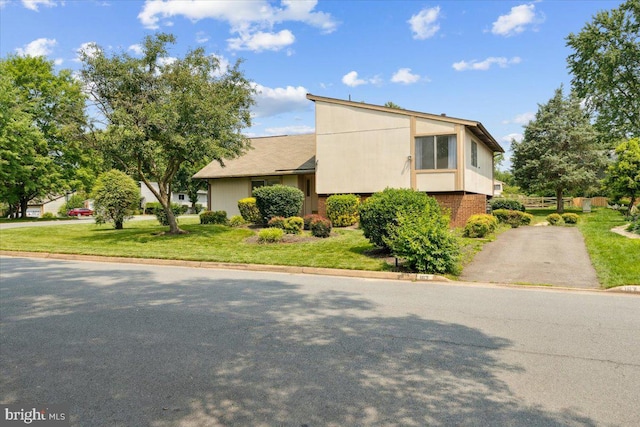 167 S Fox Rd, Sterling, VA 20164 - mid-century home with a front yard, driveway, and brick siding