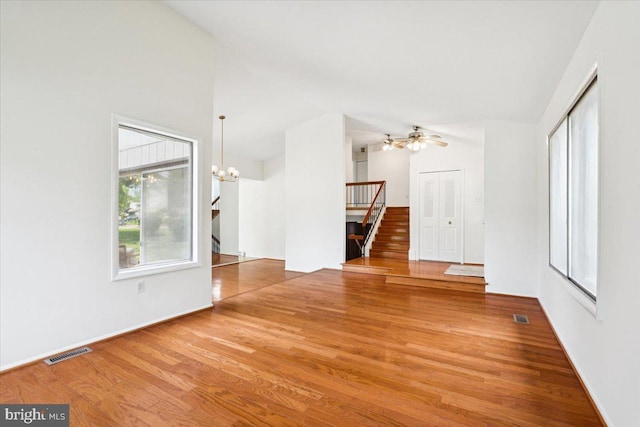 167 S Fox Rd, Sterling, VA 20164 - unfurnished room with stairway, wood finished floors, a chandelier, lofted ceiling, and a ceiling fan