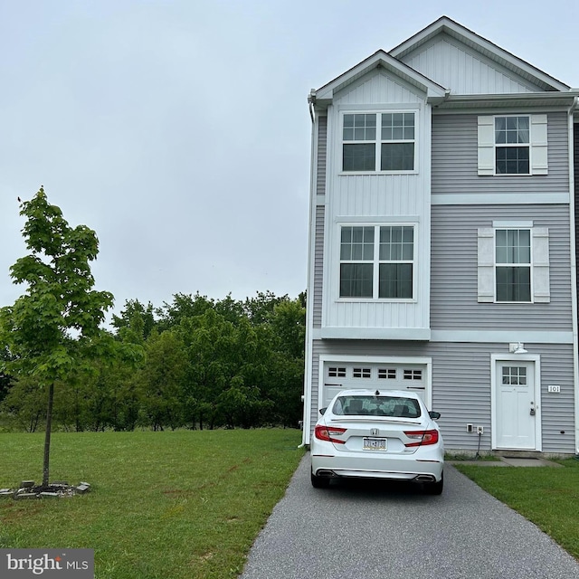 101 S Center St, Hanover, PA 17331 - view of front of property with board and batten siding, an attached garage, driveway, and a front yard