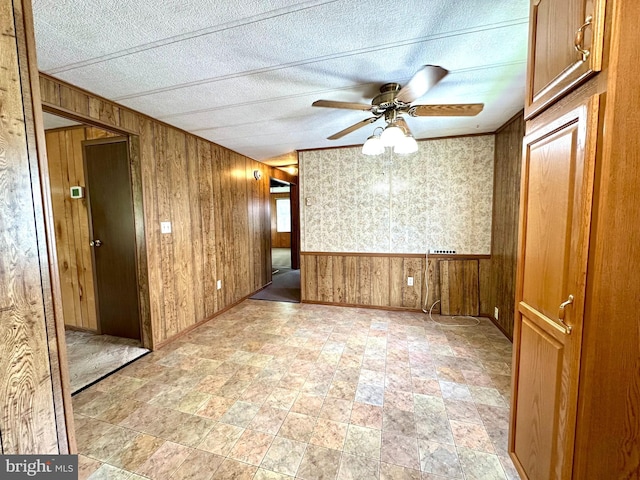 1609 Powell Ave, Hyde, PA 16843 - empty room featuring wooden walls, ceiling fan, and stone finish floors