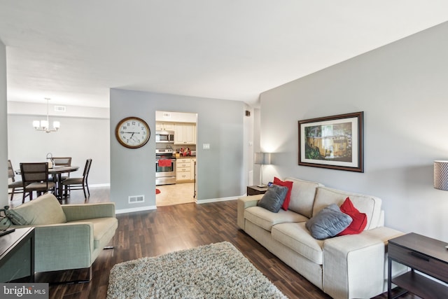 169 Woodlake Dr, Marlton, NJ 08053 - living area featuring a chandelier, dark wood-style floors, and baseboards