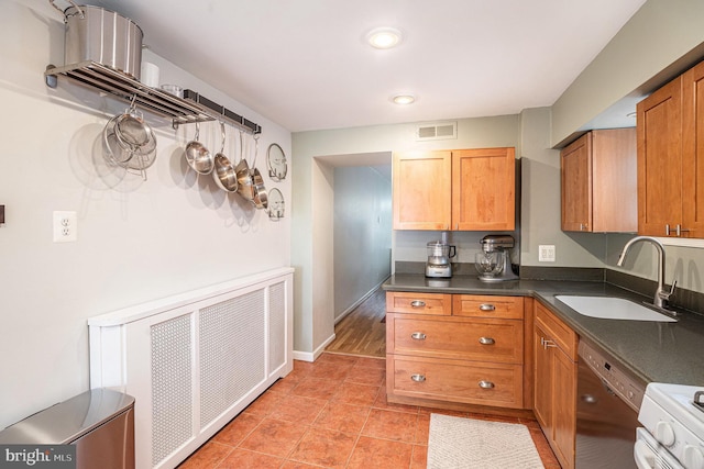 126 Ford St, Conshohocken, PA 19428 - kitchen with a sink, dishwasher, radiator heating unit, dark countertops, and brown cabinets