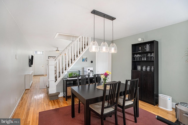 126 Ford St, Conshohocken, PA 19428 - dining room with light wood finished floors, stairs, ceiling fan, and baseboards