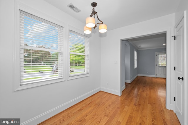 6 E Hamilton Ave, Silver Spring, MD 20901 - unfurnished dining area featuring healthy amount of natural light, baseboards, light wood-style flooring, a chandelier, and crown molding