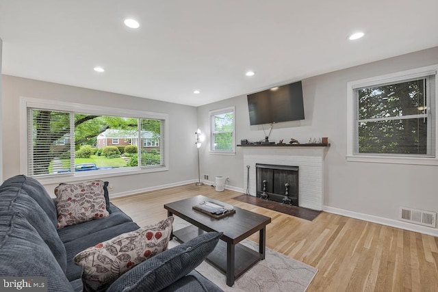 11008 Madison St, Kensington, MD 20895 - living area with a brick fireplace, baseboards, light wood-style flooring, and recessed lighting