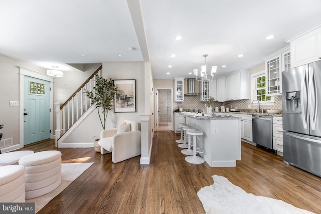 10510 Vincent Rd, White Marsh, MD 21162 - kitchen with stainless steel appliances, wall chimney exhaust hood, a kitchen island, a chandelier, and a kitchen breakfast bar