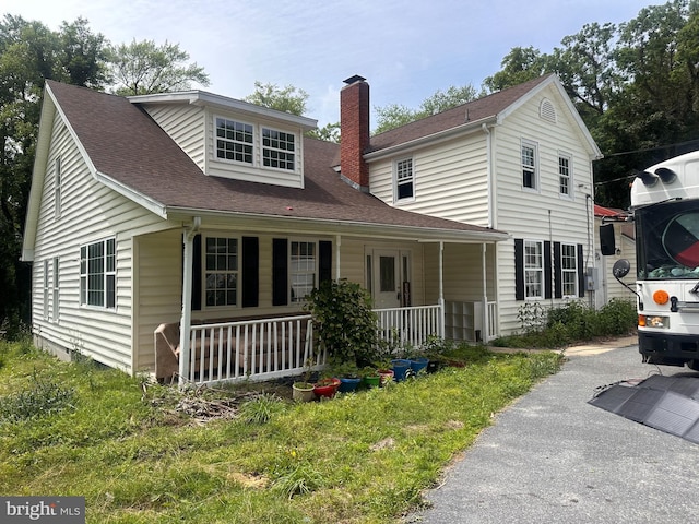 17286 Apple Tree Rd, Bridgeville, DE 19933 - view of front of house featuring covered porch, a chimney, and a shingled roof