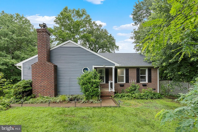 187 Tanglewood Ln, Stafford, VA 22554 - view of front of house featuring a chimney, brick siding, and roof with shingles