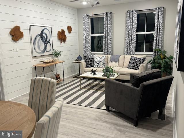 406-203 Bold Ruler Ct, Havre De Grace, MD 21078 - living area featuring wood finished floors, wood walls, and a ceiling fan