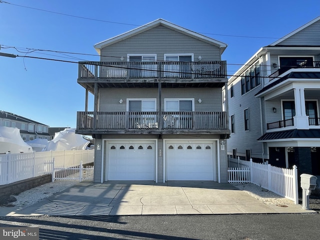 557 Launch Ave, Somers Point, NJ 08244 - view of front of home with driveway, a garage, and a balcony