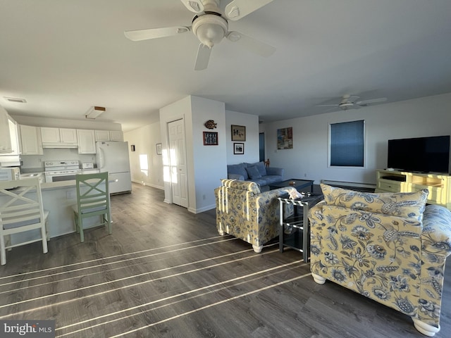 557 Launch Ave, Somers Point, NJ 08244 - living area featuring a ceiling fan, dark wood-style flooring, baseboard heating, and baseboards