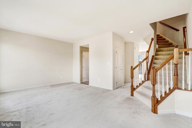 9207 Cascade Falls Dr, Bristow, VA 20136 - unfurnished living room featuring carpet, baseboards, stairs, and recessed lighting
