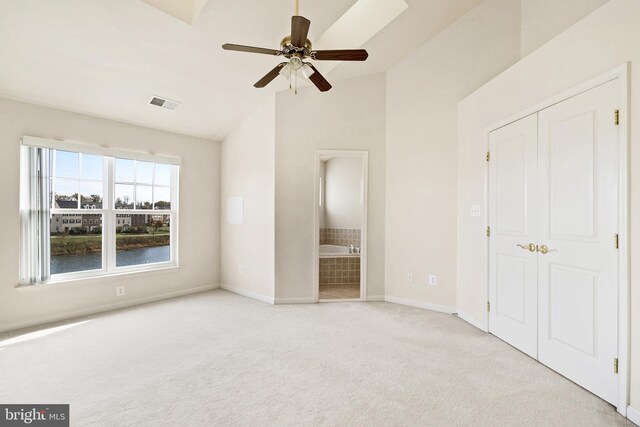 9207 Cascade Falls Dr, Bristow, VA 20136 - unfurnished bedroom with carpet flooring, lofted ceiling, baseboards, a closet, and ensuite bath