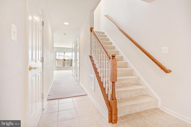 9207 Cascade Falls Dr, Bristow, VA 20136 - stairs featuring tile patterned flooring, baseboards, carpet, and recessed lighting