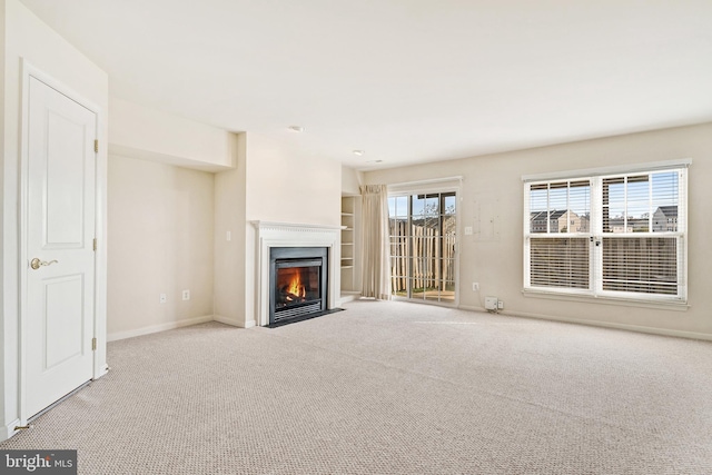 9207 Cascade Falls Dr, Bristow, VA 20136 - unfurnished living room featuring a fireplace with flush hearth, carpet floors, and baseboards